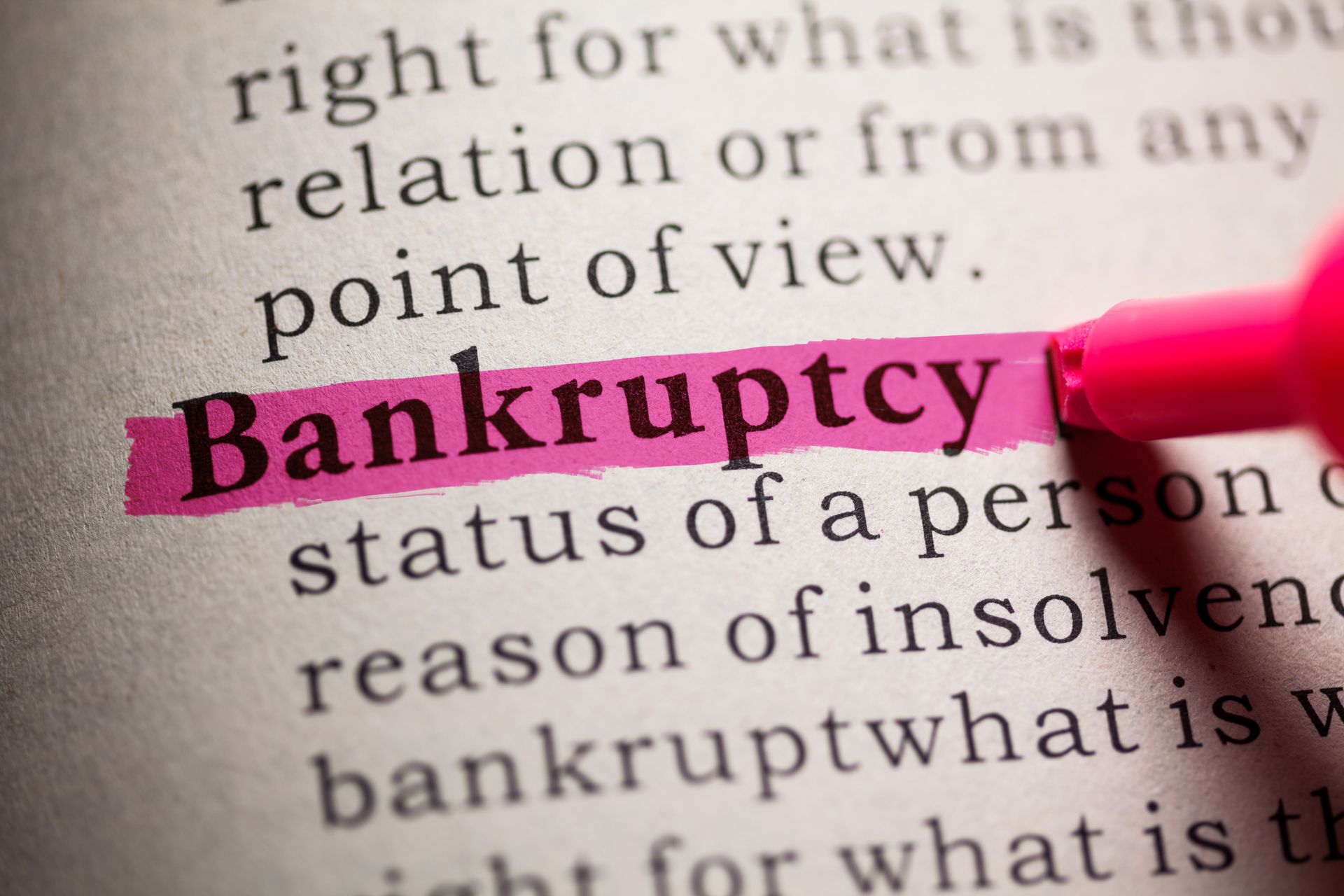 Close-up of “bankruptcy” highlighted in pink with marker on printed text page.