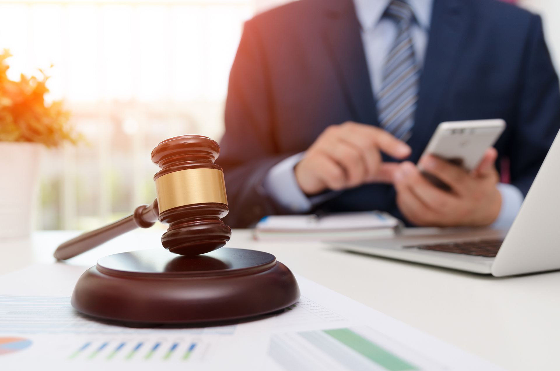 Justice symbol highlighted, showcasing a bankruptcy attorney working in a professional office. Justice symbol highlighted, showcasing a bankruptcy attorney working in a professional office.