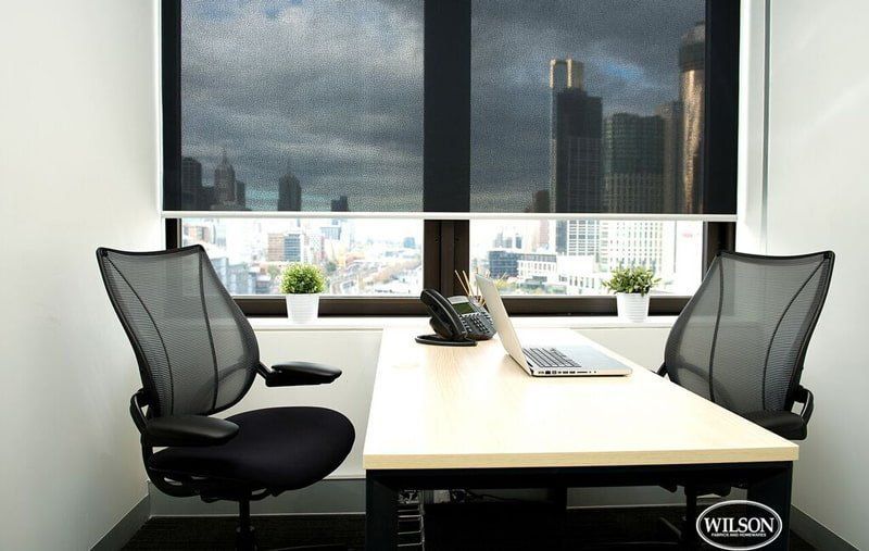A Wilson Chair Sits Next to A Desk with A Laptop on It — Creative Curtains & Blinds In Tweed Heads South, NSW