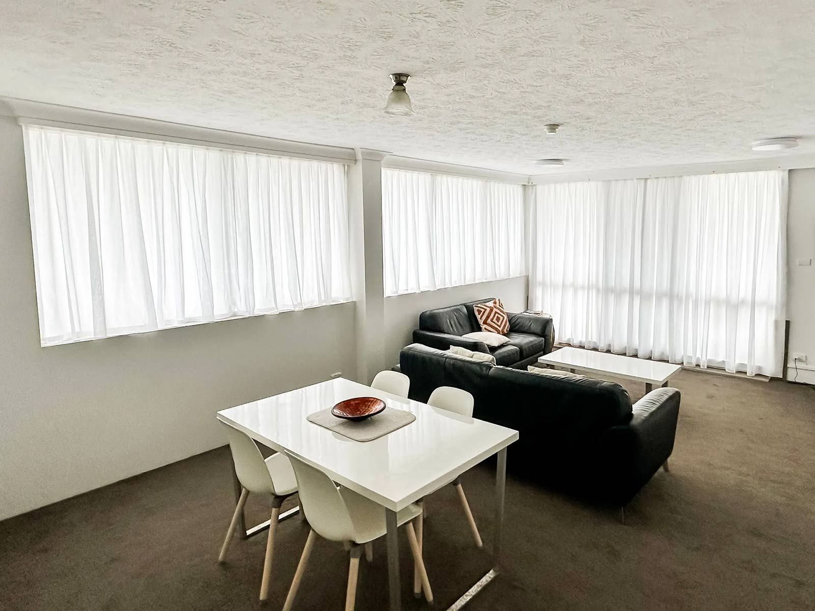 Living Room With A Table And Chairs And A Couch — Creative Curtains & Blinds In Tweed Heads South, NSW