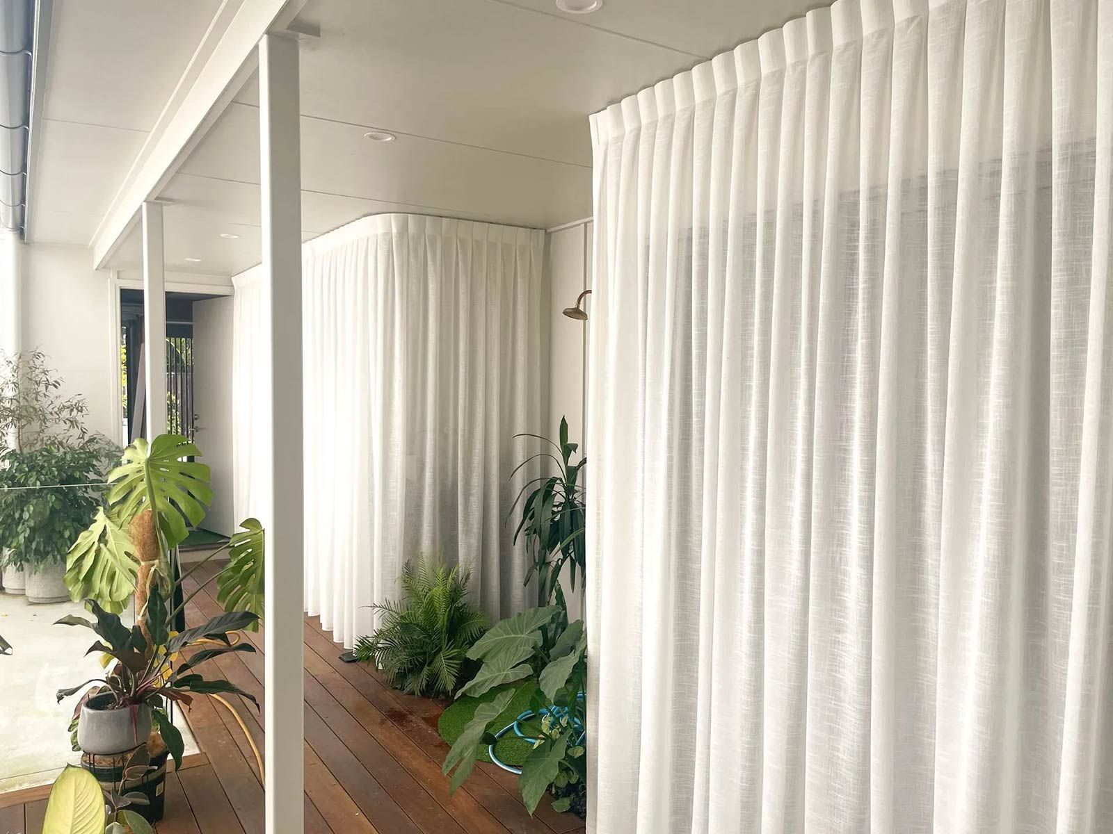 A Porch with White Curtains and Potted Plants — Creative Curtains & Blinds In Tweed Heads South, NSW