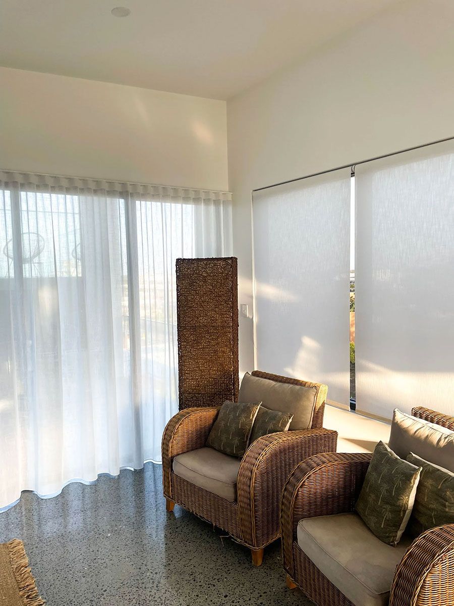 A Living Room with Wicker Furniture and A Large Window — Creative Curtains & Blinds In Tweed Heads South, NSW