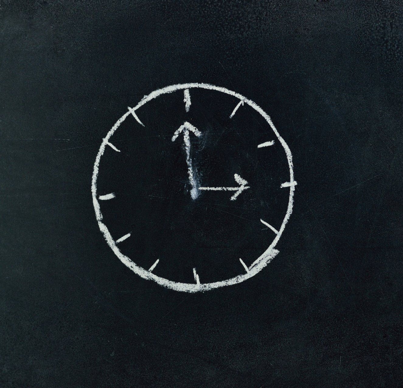 Drawing of a clock on a chalkboard
