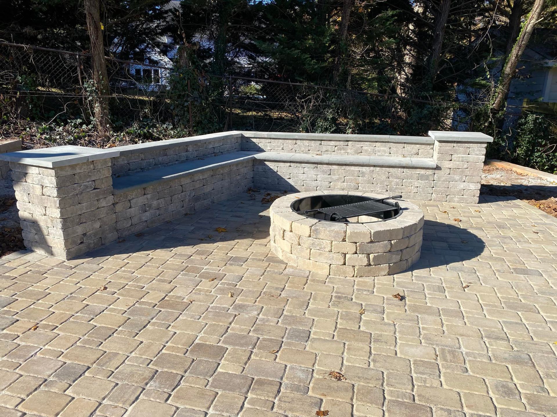 Stone steps beside a stacked-stone retaining wall and wooden post in a landscaped yard