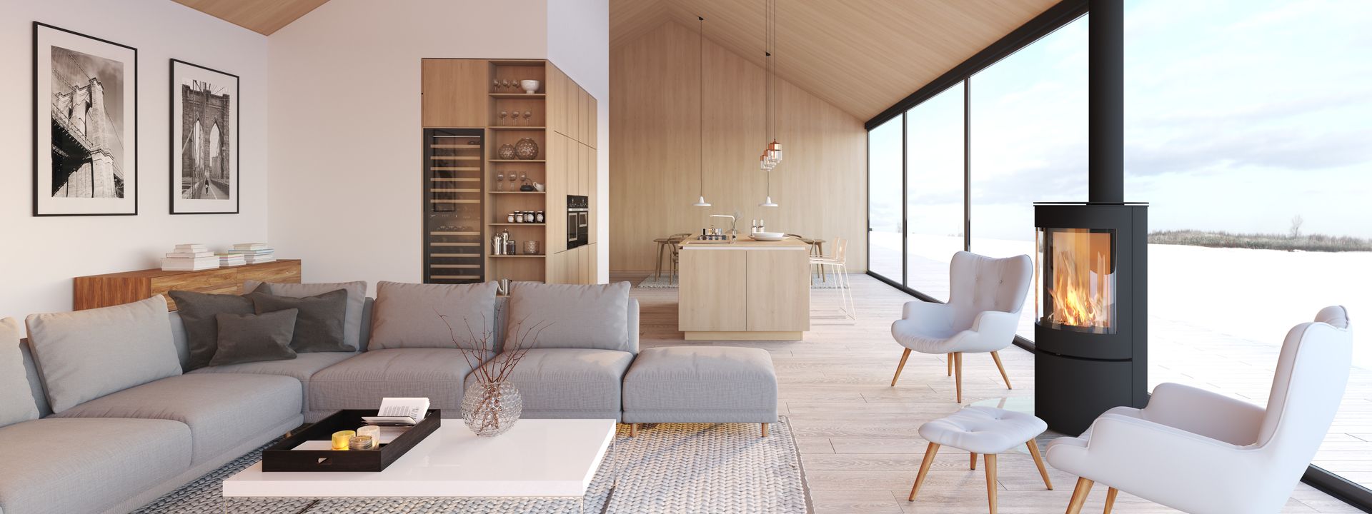 A modern living room with a gray sectional sofa, fireplace, and large windows overlooking water.