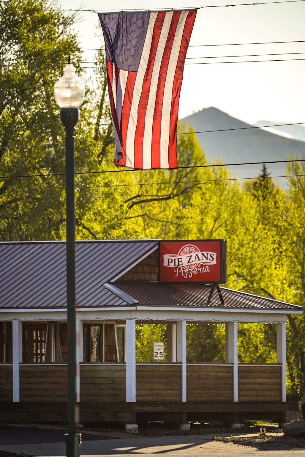 pie zans building in the summer with an american flag flag