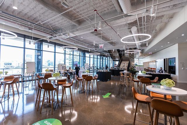 A large room with tables and chairs in it.