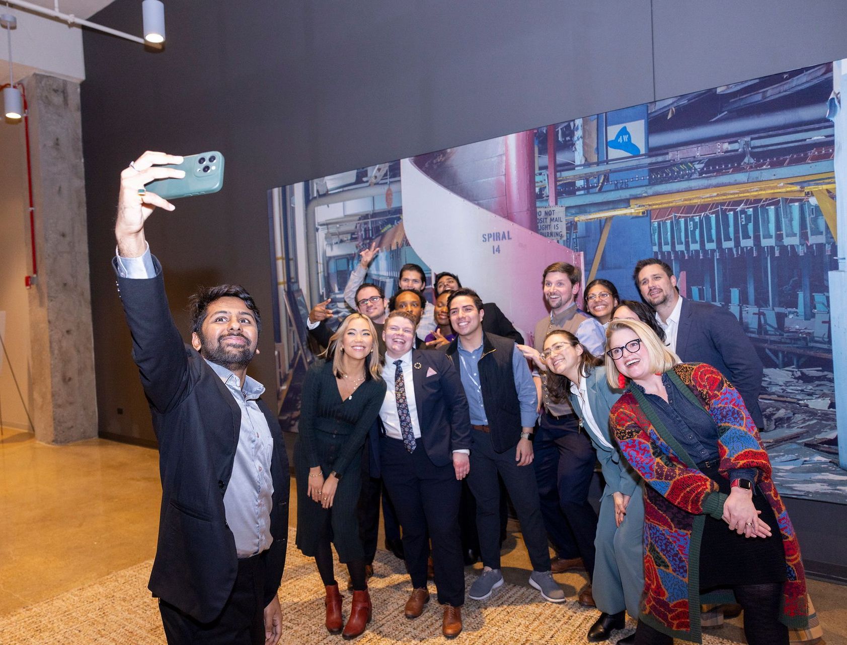 A man is taking a selfie with a group of people.