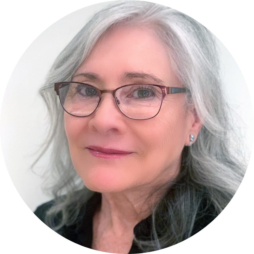 A smiling woman in glasses and a black shirt.