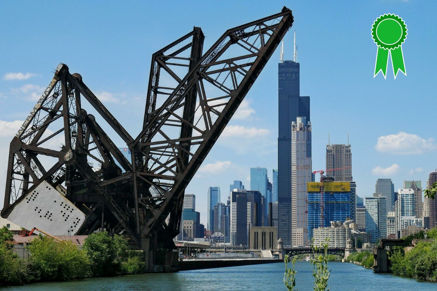 A bridge over a river with a city skyline in the background
