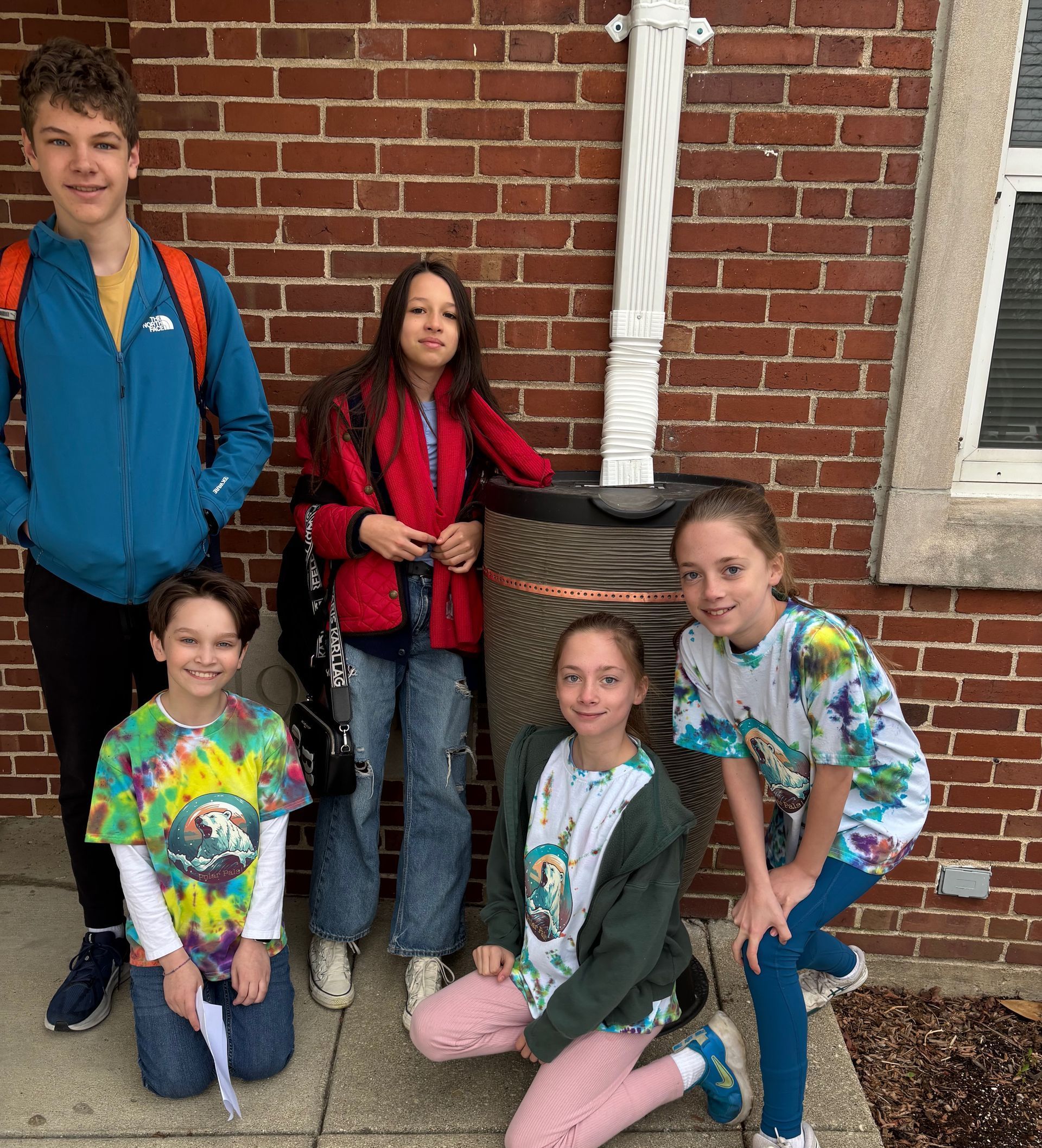 Students posing with a new rain barrel.