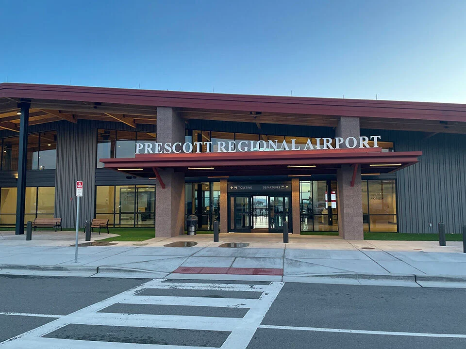 Prescott Regional Airport entrance with signage and glass doors.