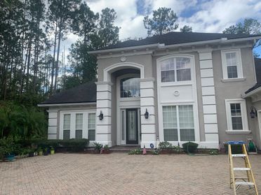 A large house with a ladder in front of it.
