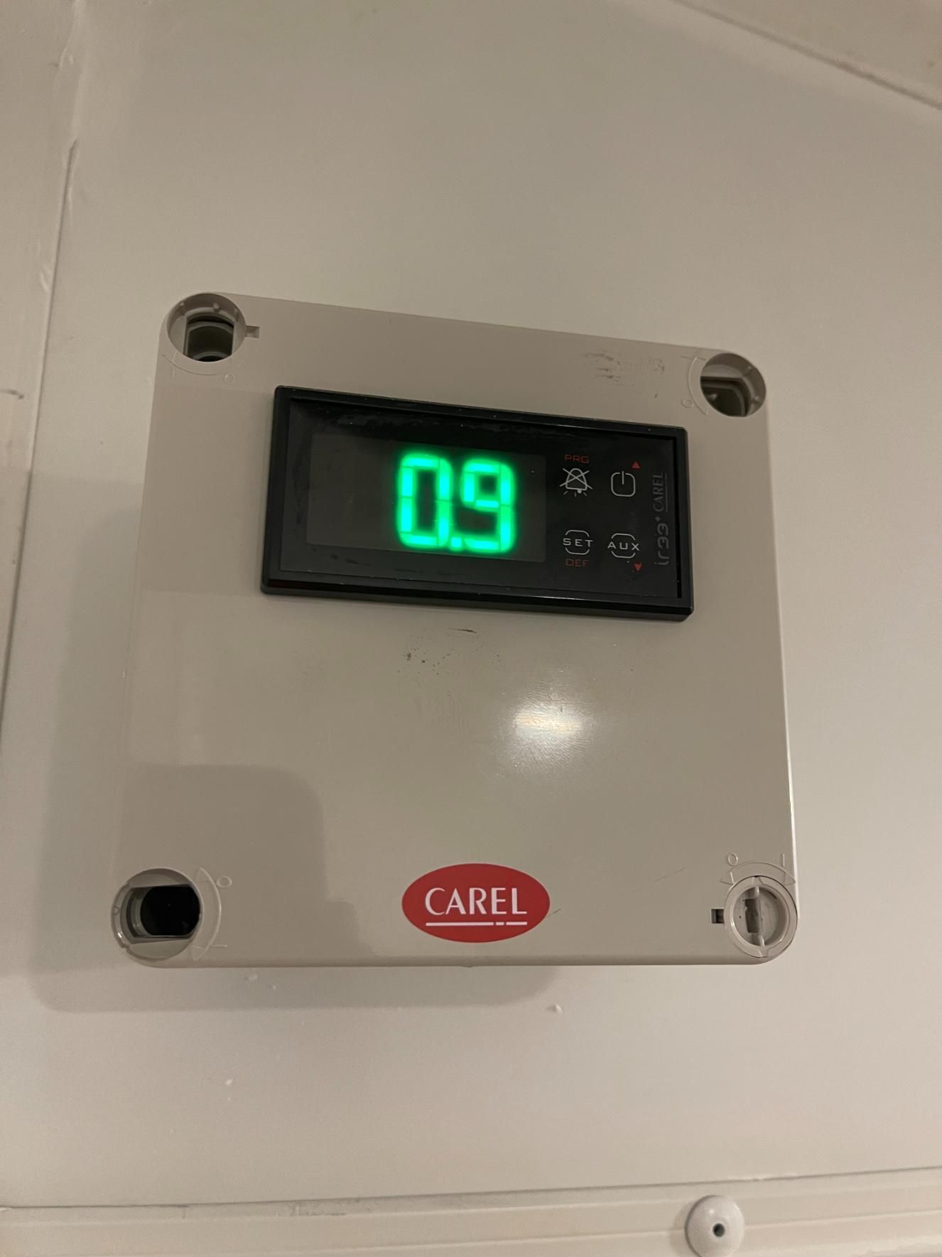 A Digital Thermostat is Hanging on a White Wall — Condie Refrigeration & Air Conditioning In Murwillumbah, NSW