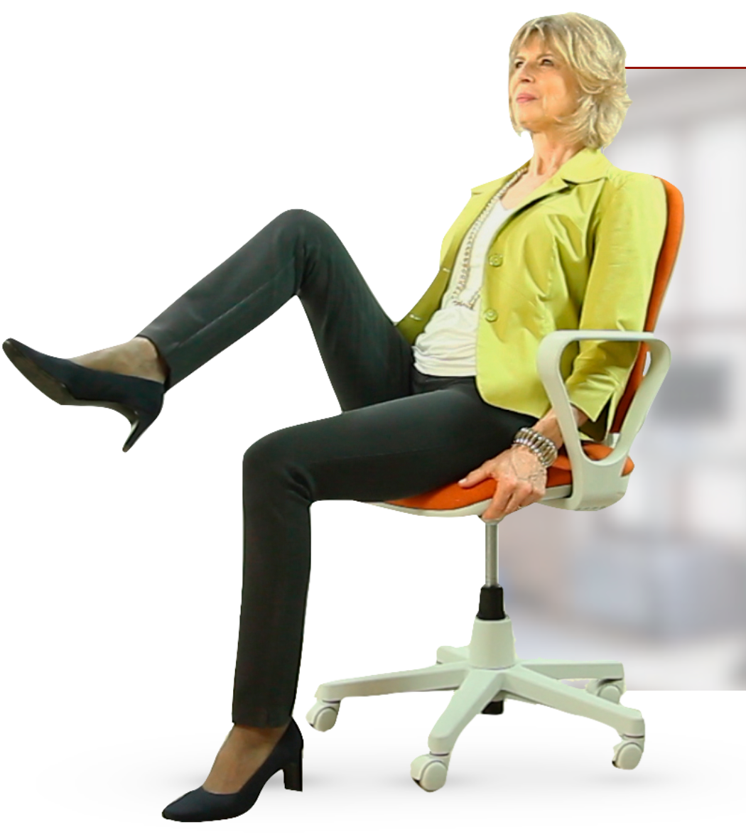 A woman seated in an office chair, raising one leg in a desk exercise.