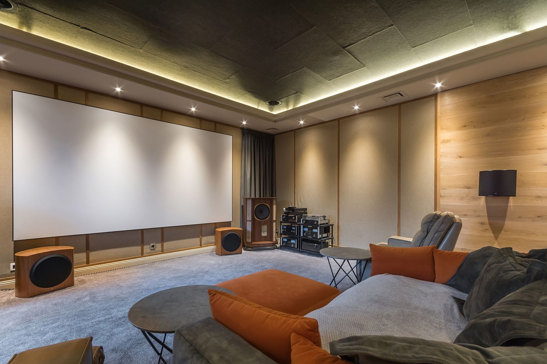 A home theater with a large screen and a couch.