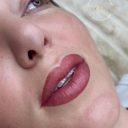 Close-up of a face with matte mauve lipstick and silver teeth jewelry
