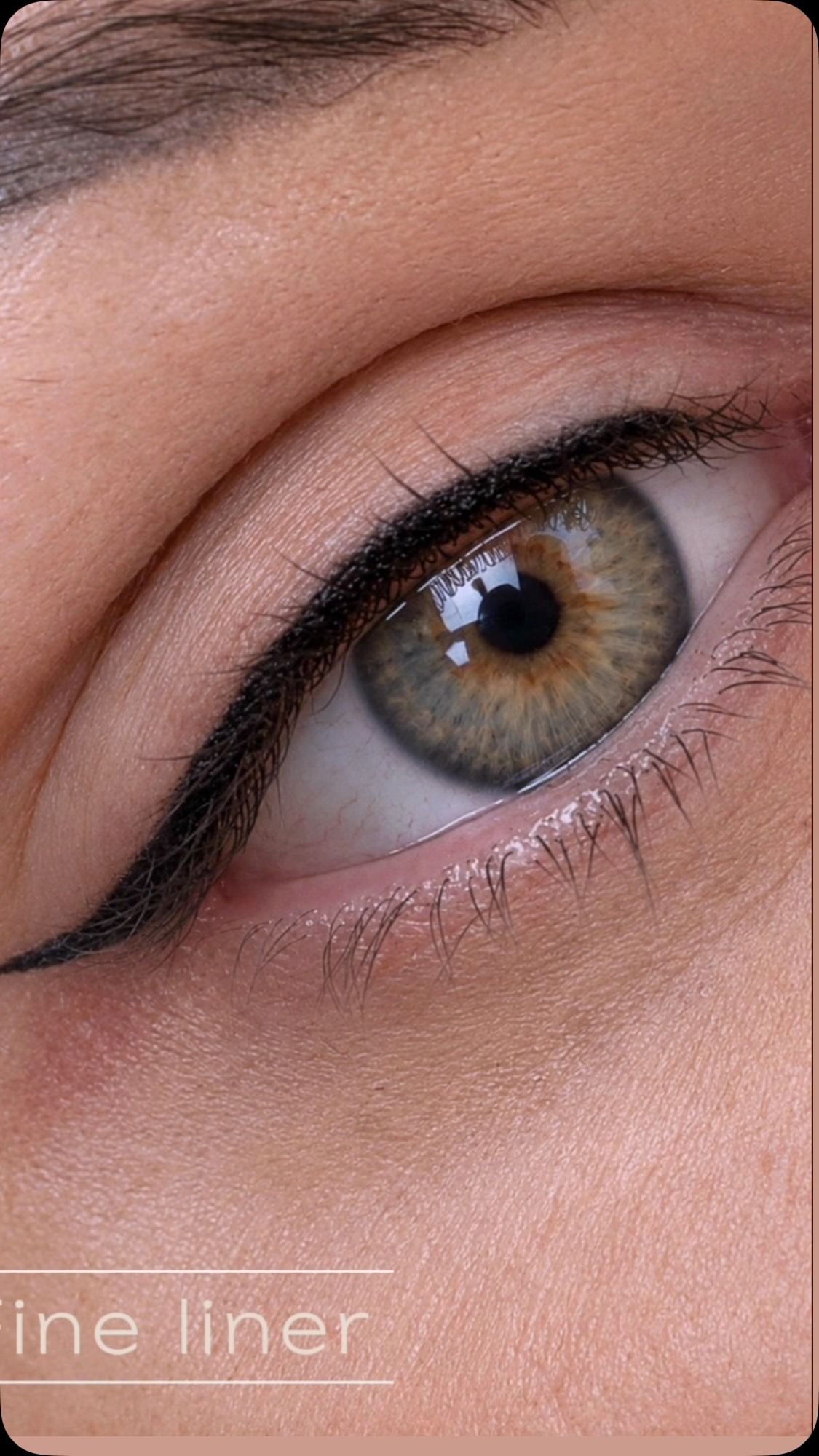 Close-up of a brown eye with subtle black eyeliner and pink eyeshadow
