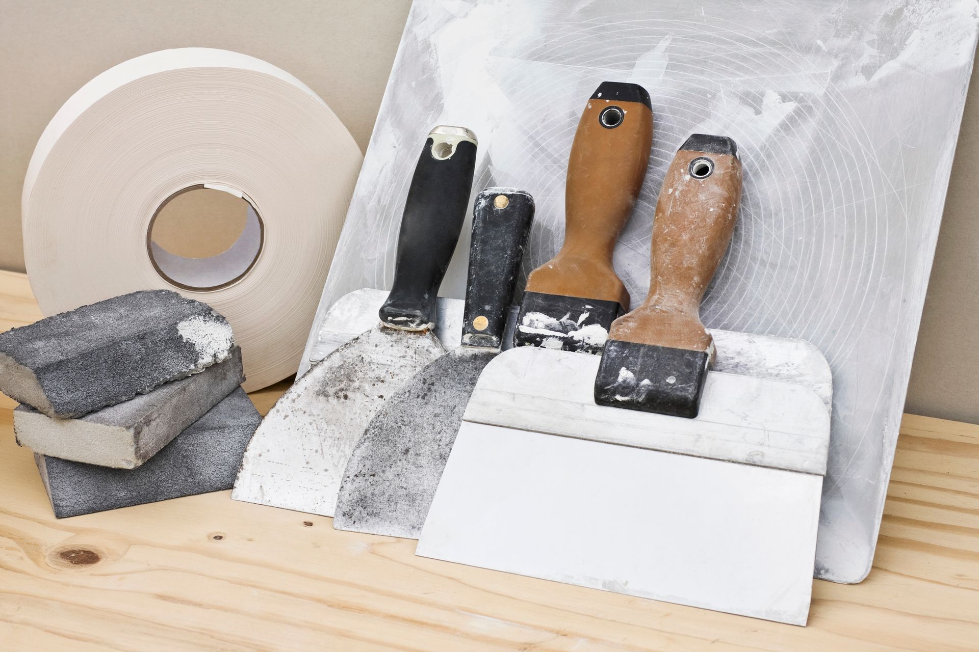 A wooden table topped with tools and tape.
