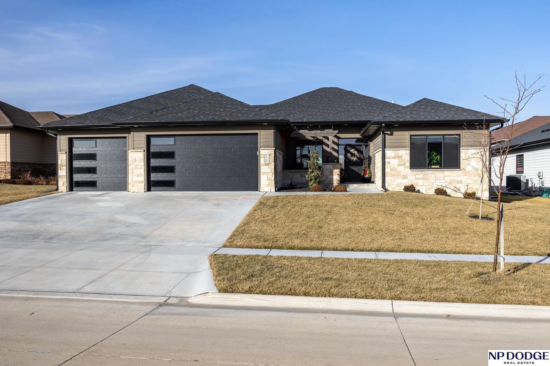 House With Stone Exterior And Lawn
