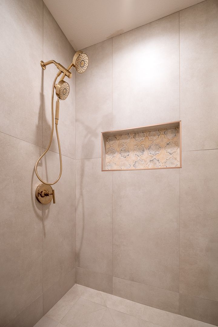 Shower With Gold Fixtures And Niche