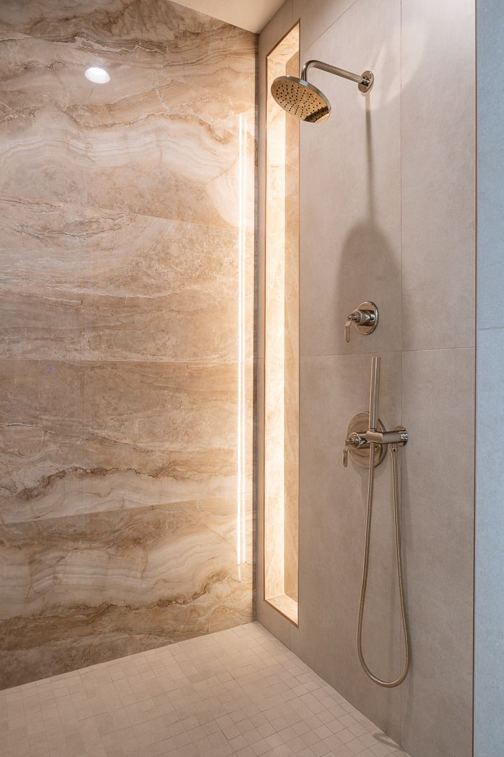 Shower With Stone Walls And Chrome Fixtures
