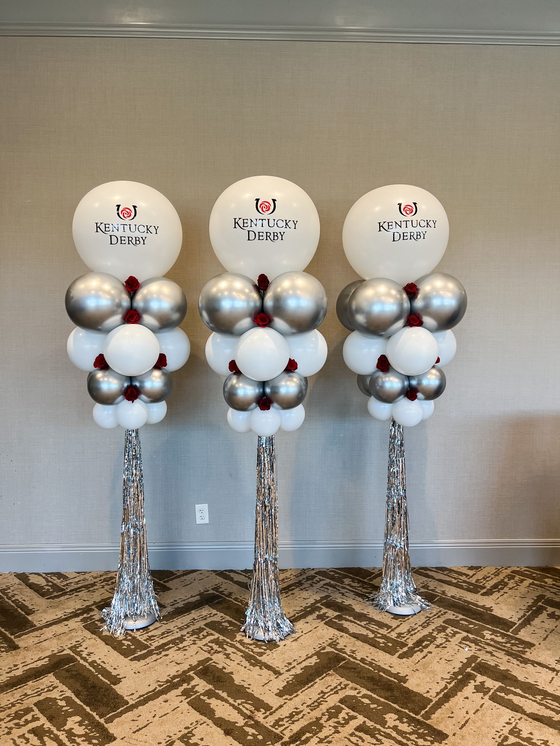 three balloons are stacked on top of each other in a room