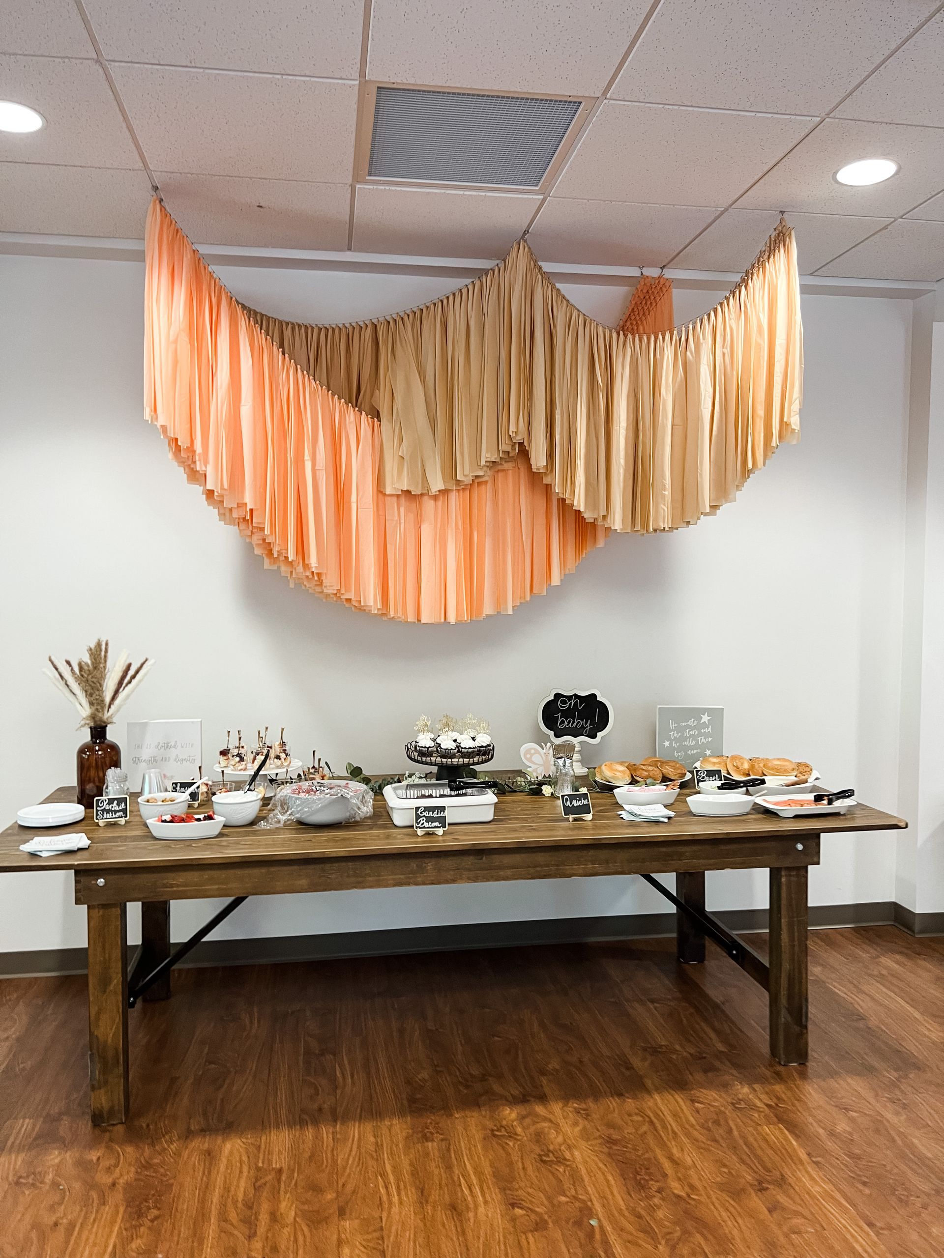 a long wooden table with a buffet set up on it in a room