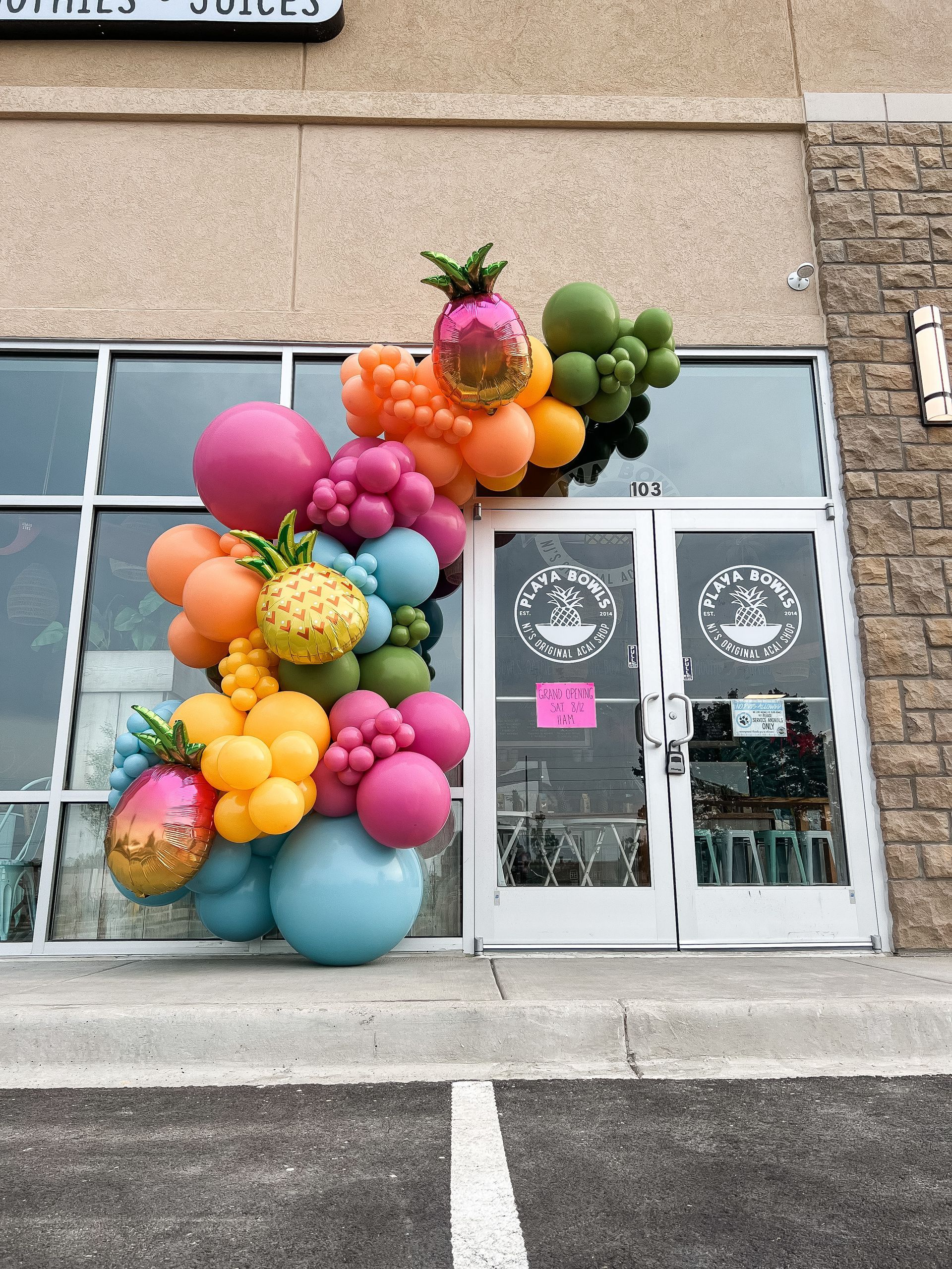 a bunch of colorful balloons are in front of a store