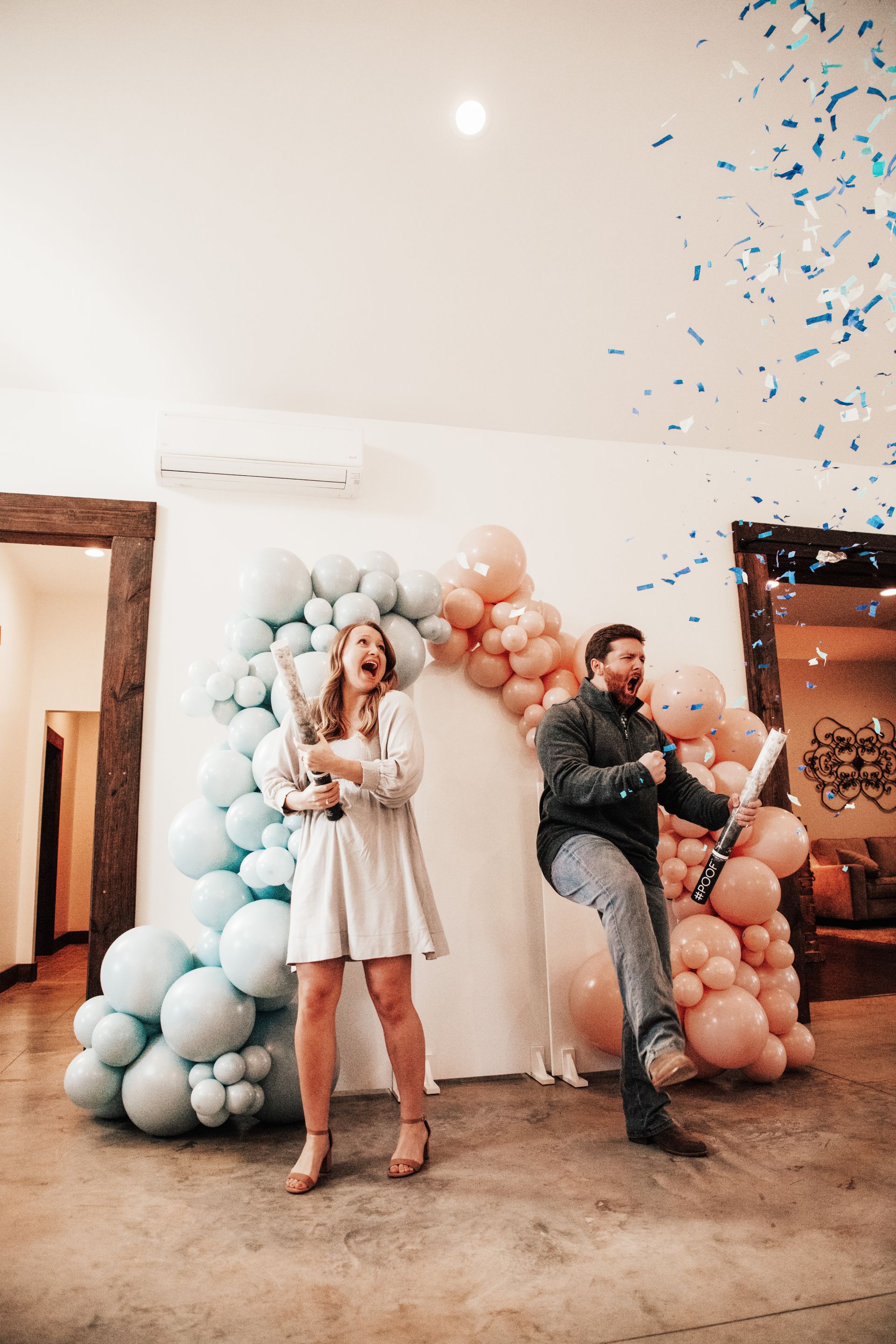 A room filled with balloons and a pink bow for a baby shower.