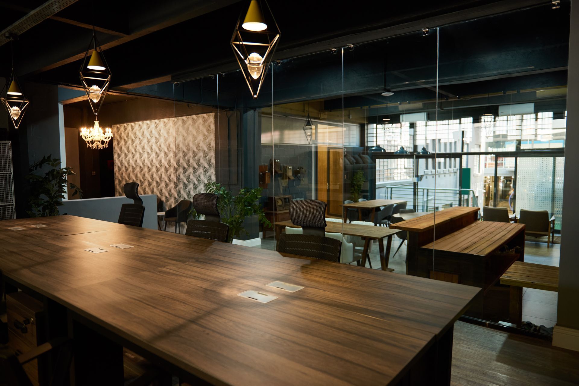 The interior of a modern boardroom with a wooden conference desk and glass walls after hours. The interior of a modern boardroom with a wooden conference desk and glass walls after hours.