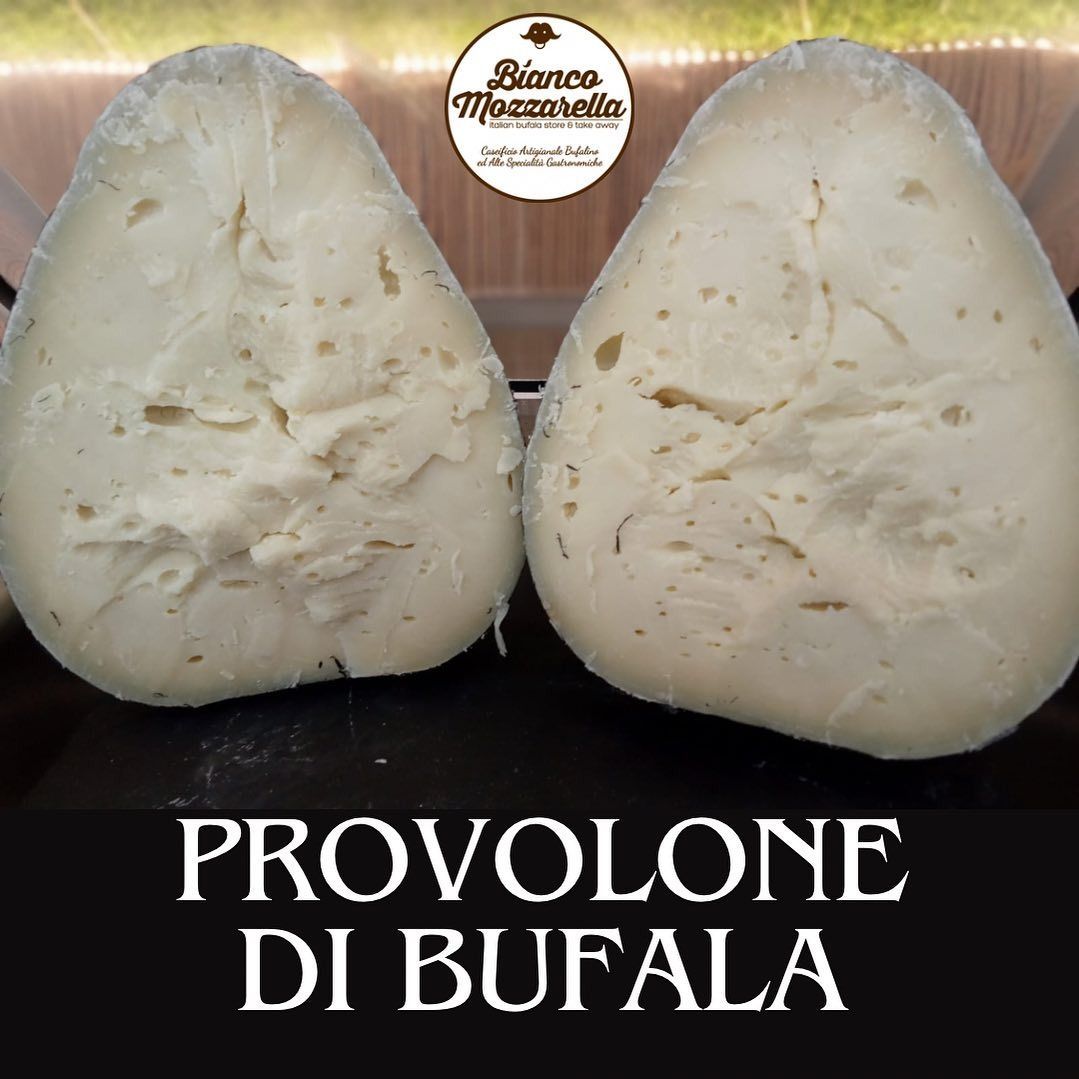 Two large, pale provolone di bufala cheeses side by side. Text: