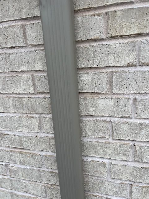 pro roofing and construction gray gutter installation