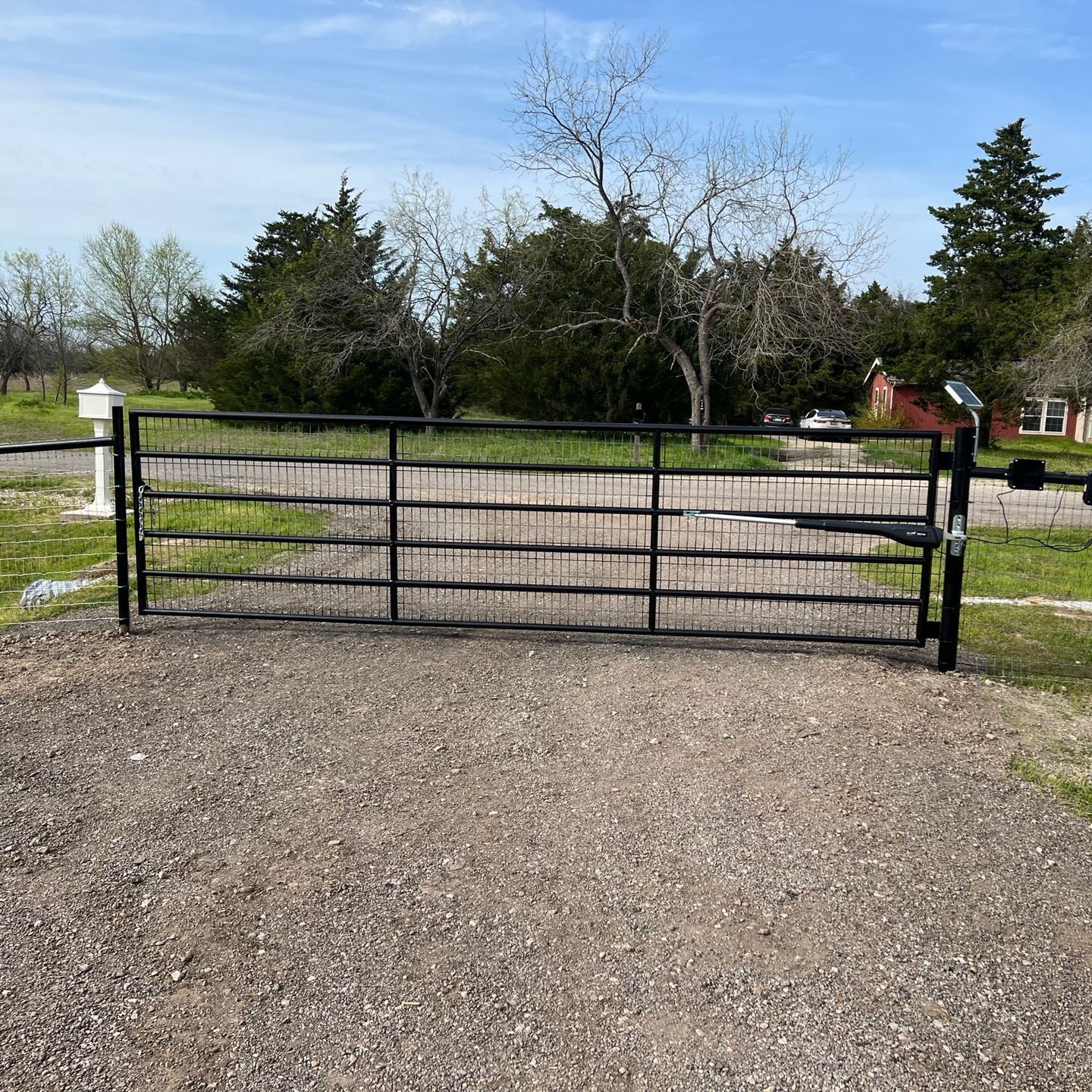 custom fence with automatic gate by pro roofing and construction
