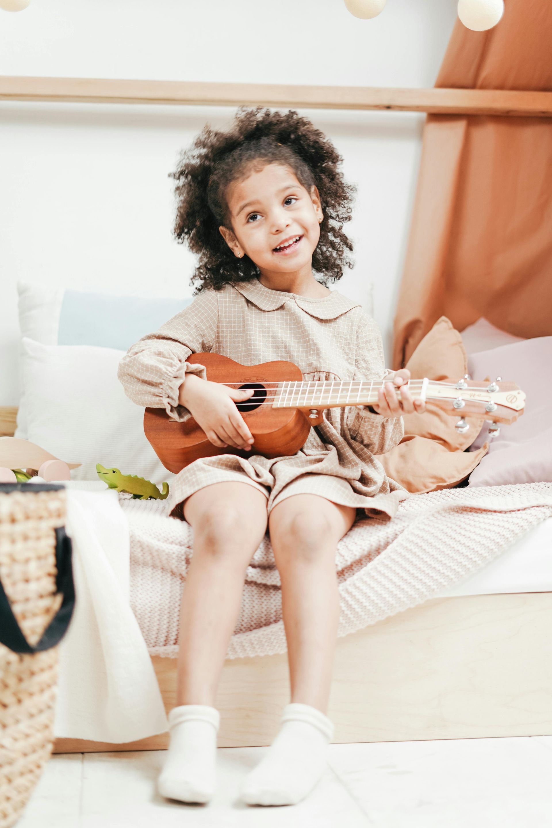 Young girl playing ukelele
