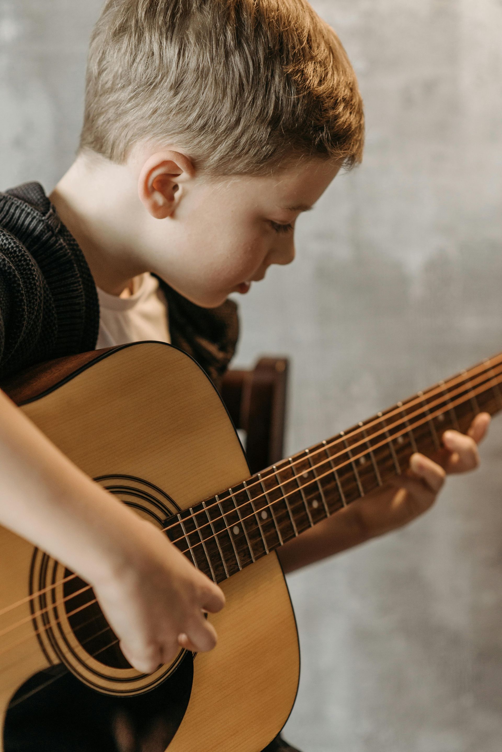 Young boy playing a guitar