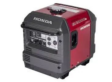 Red Honda portable generator with black control panel and handle on a white background