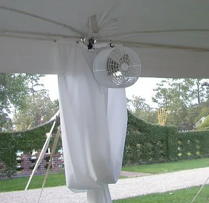 White outdoor canopy with a hanging fan and draped curtain on a patio or event tent