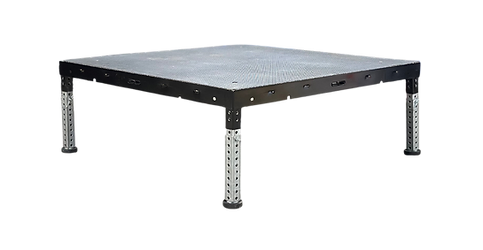 Black metal platform table with four perforated silver legs on a white background