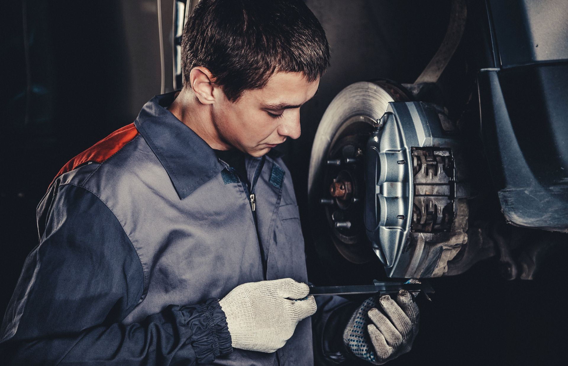 Professional car mechanic repairing brakes in auto repairing shop | Charlestown 