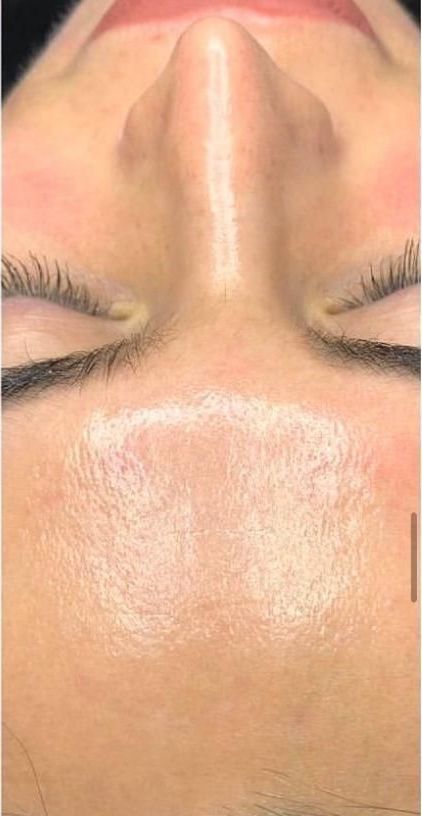 A close up of a woman 's face with her eyes closed.