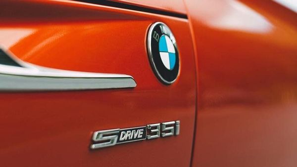 Close-up of a red BMW car door with the BMW badge and sDrive 35i emblem