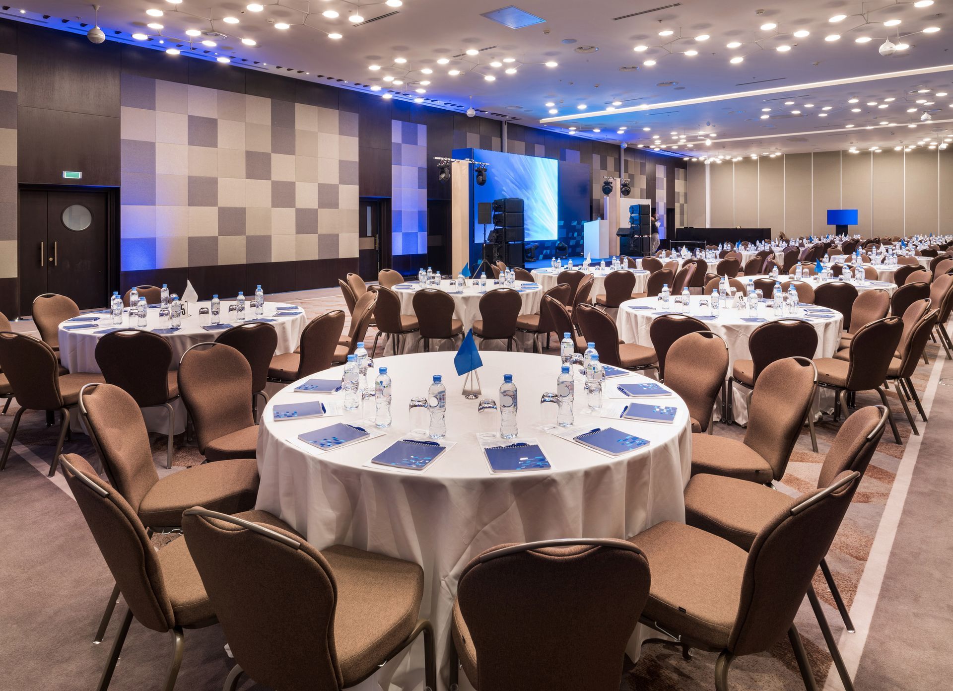 A large conference room with tables and chairs set up for a meeting.