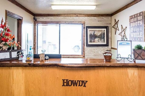 A rustic wooden front desk with a 