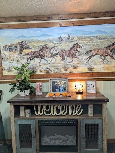 A rustic TV stand with a fireplace, featuring a 