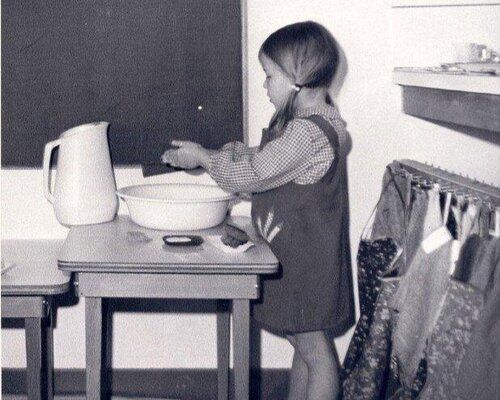 Montessori child washing her hands