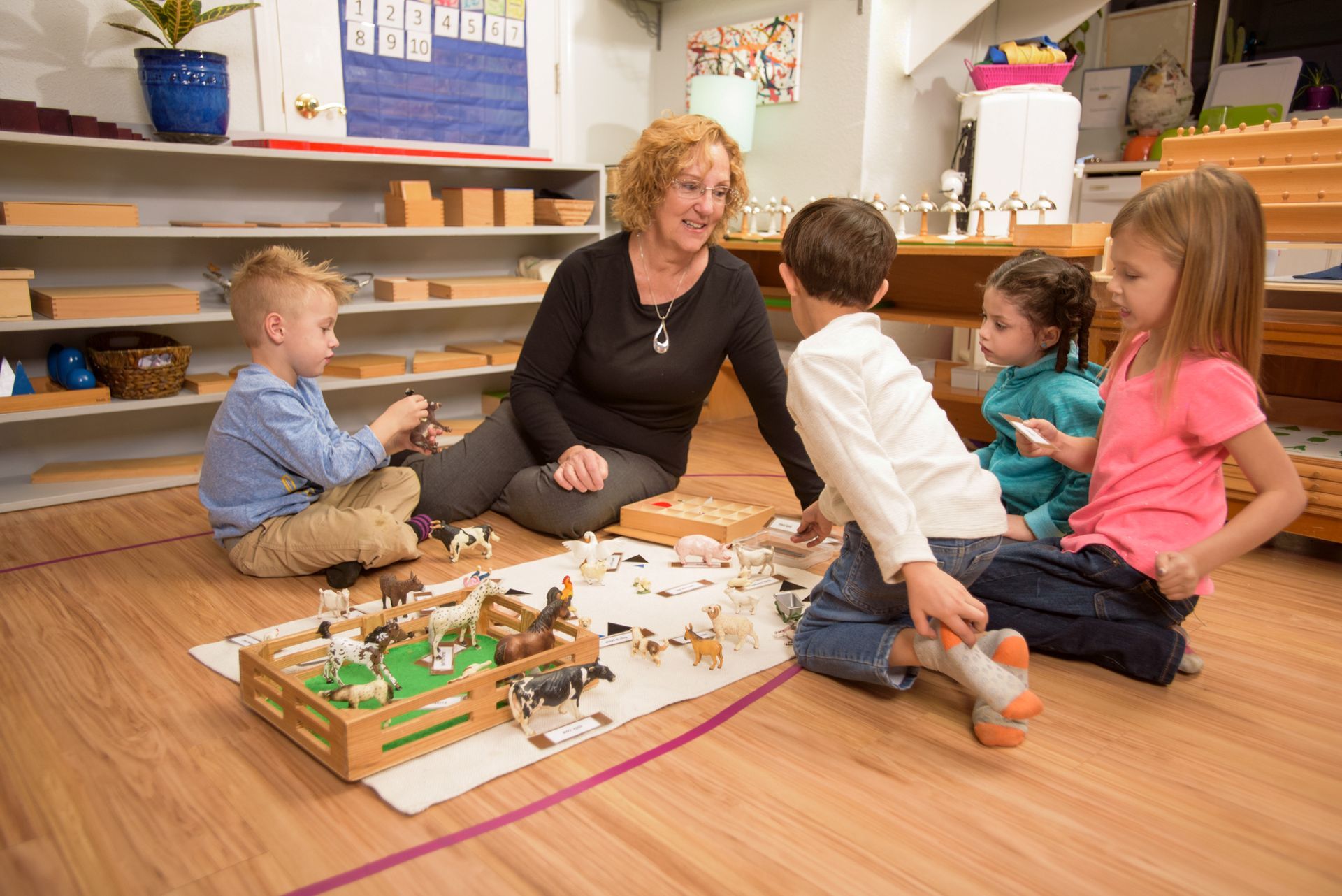 Children and guide in a Montessori classroom