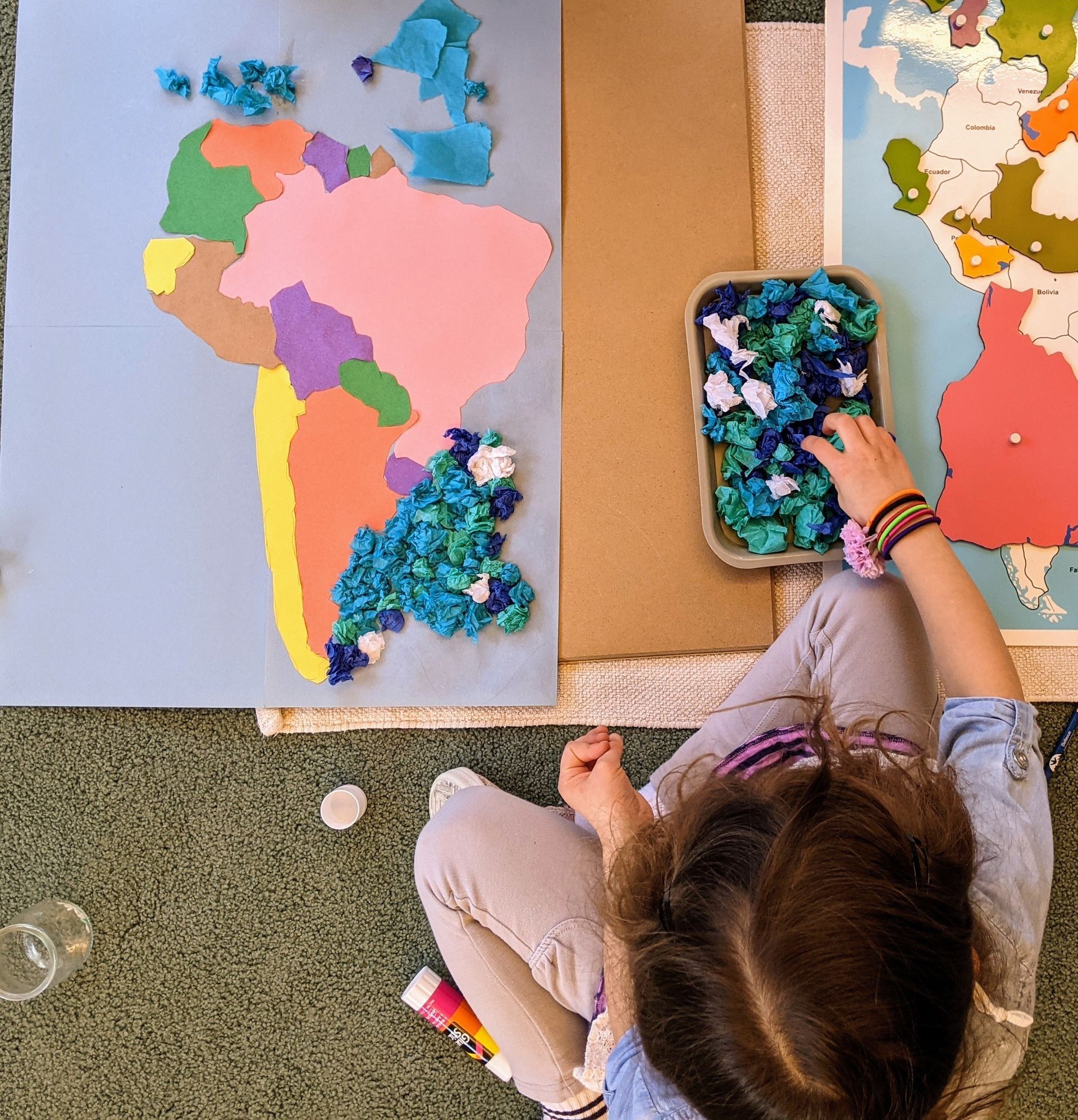 Montessori child grabbing a color pencil