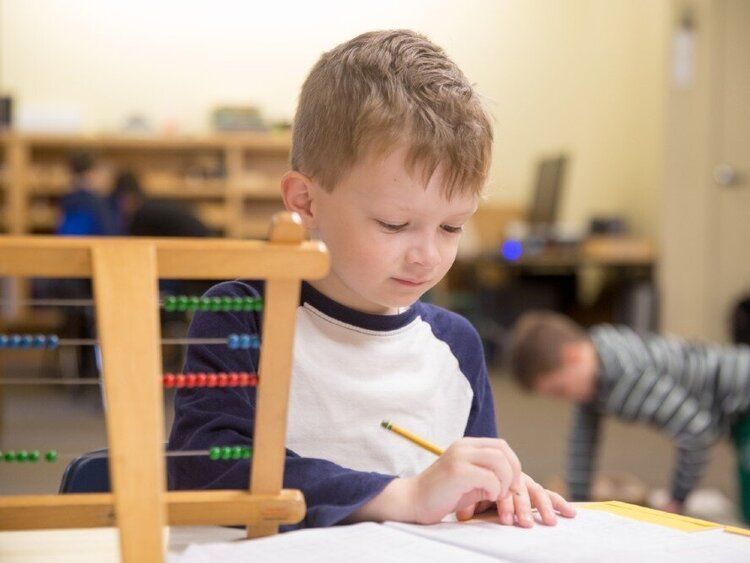 Child working with Montessori materials