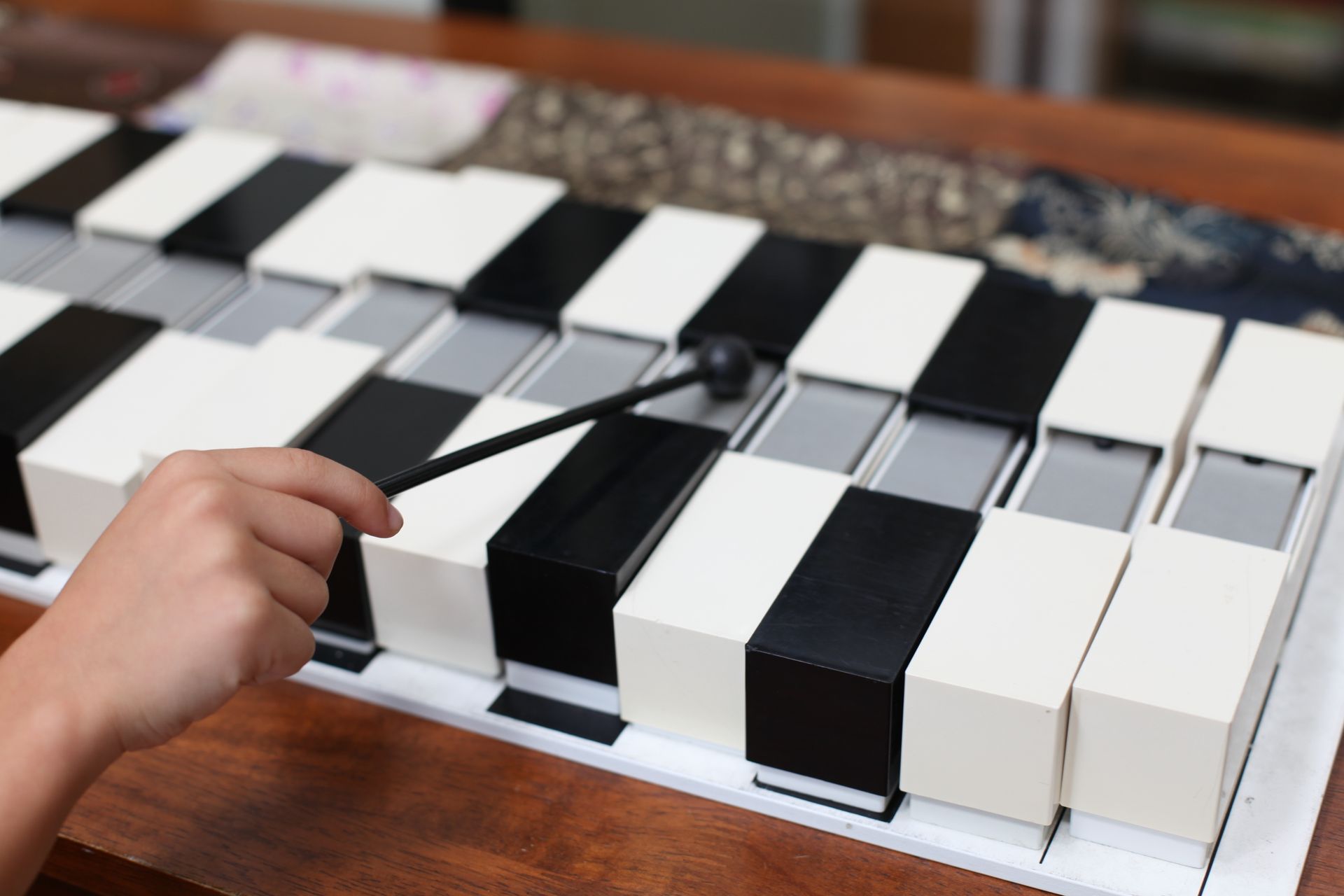 Montessori child playing a musical instrument